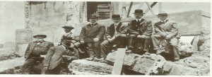 Founder John Stauffer (second from right) sits on the ruins of the North Beach plant after the 1906 earthquake.